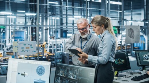 Car,factory,office:,manager,talks,with,senior,engineer,,use,tablet