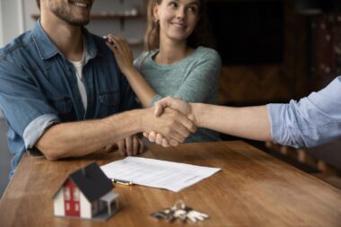 Close,up,of,happy,young,caucasian,couple,buyer,handshake,close