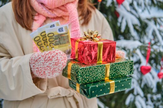 A,happy,woman,stands,with,money,in,euros,at,a