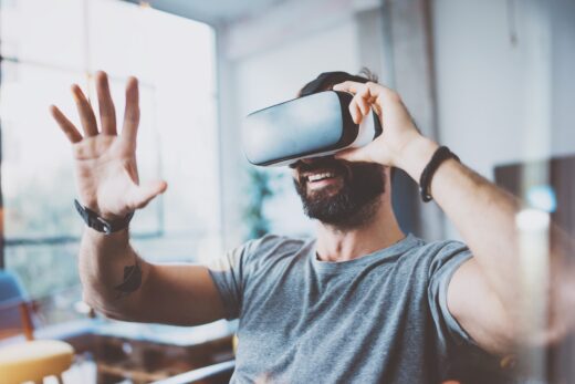 Young,bearded,man,wearing,virtual,reality,glasses,in,modern,interior