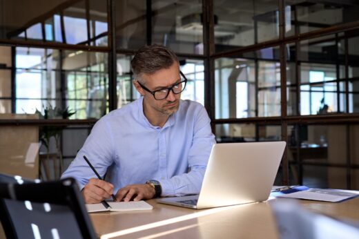 Mature,business,man,executive,manager,looking,at,laptop,computer,watching