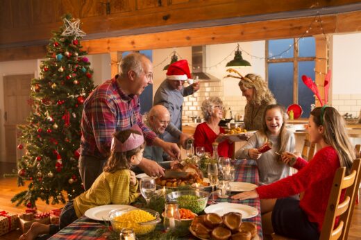 A,large,family,are,all,helping,serve,christmas,dinner.