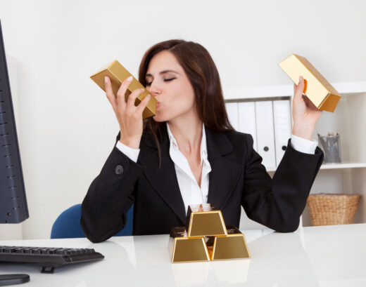 Portrait,of,a,beautiful,young,businesswoman,holding,gold,bar,at