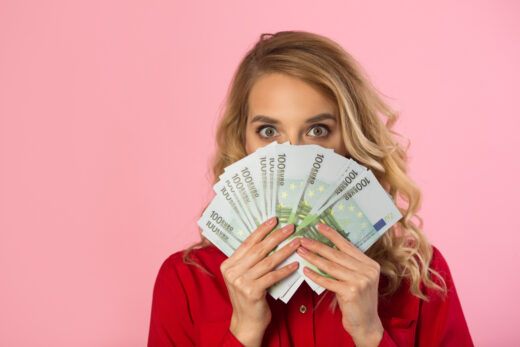 Beautiful,young,girl,in,a,red,shirt,with,euros,in