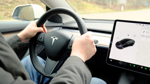 Male,hands,on,steering,wheel,of,electric,car,tesla,model
