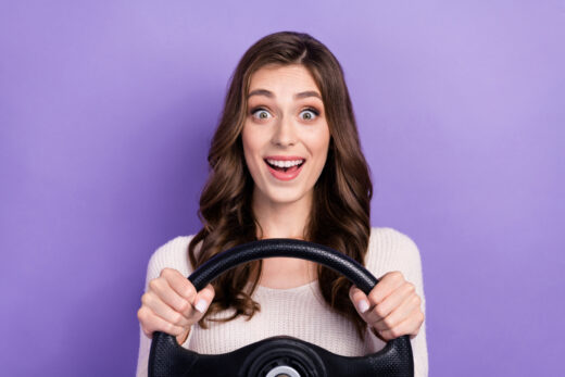 Photo,of,astonished,adorable,lady,hold,steering,wheel,enjoy,speed