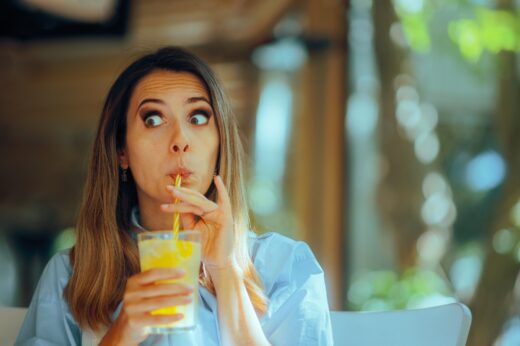 Woman,drinking,a,lemonade,beverage,in,a,restaurant,customer,in