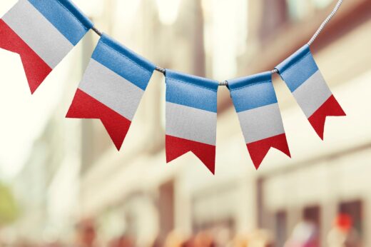 A,garland,of,france,national,flags,on,an,abstract,blurred