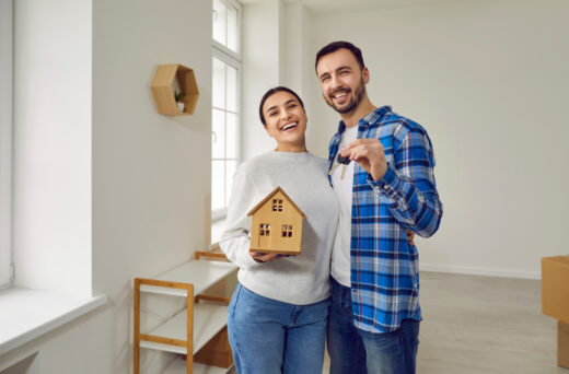 Happy,married,couple,together,hold,keys,to,their,new,modern