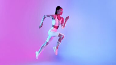 Motivated,fitness,lady,jumping,or,running,in,mid Air,looking,at
