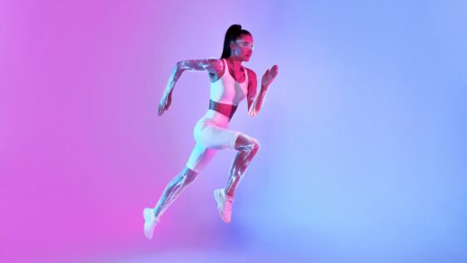 Motivated,fitness,lady,jumping,or,running,in,mid Air,looking,at