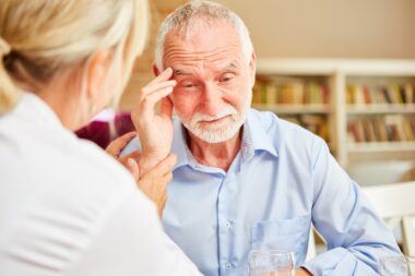 Senior,with,dementia,or,alzheimer's,is,comforted,by,caring,female