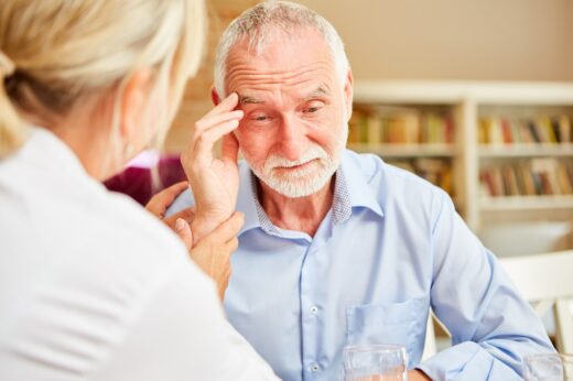 Senior,with,dementia,or,alzheimer's,is,comforted,by,caring,female