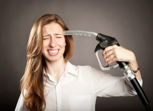 Young,woman,shooting,herself,with,a,fuel,pump,nozzle