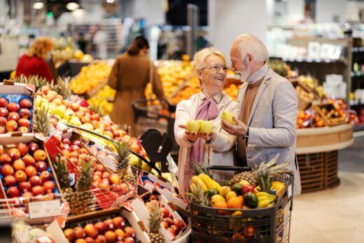 A,cheerful,senior,couple,is,picking,fresh,fruits,at,the
