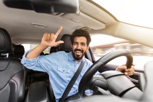 Happy,handsome,young,indian,man,driver,going,summer,vacation,by
