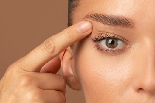 Closeup,of,young,european,woman,pointing,to,the,wrinkles,on